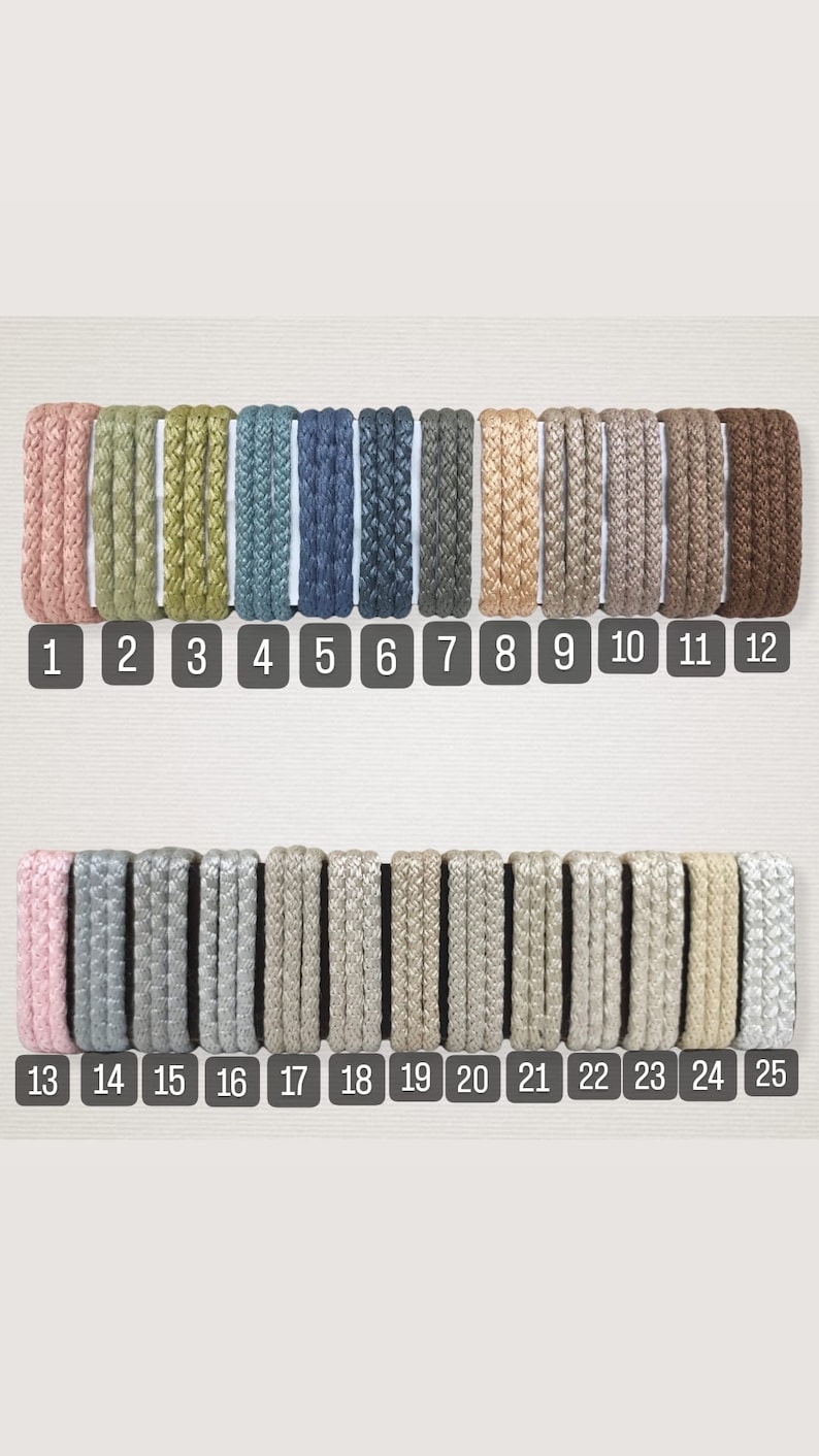 May include: A collection of 25 different colors of braided cord, arranged in two rows. The cords are all the same thickness and have a subtle sheen. The cords are numbered 1 through 25.
