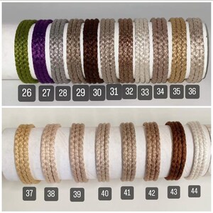 May include: A collection of 11 different colors of braided cord, numbered 26 through 44. The cords are all the same size and are arranged in two rows.