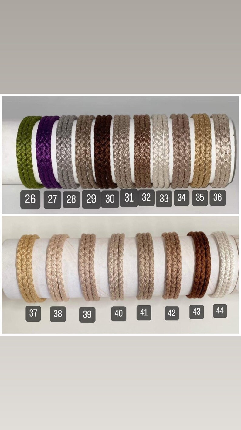 May include: A collection of 11 different colors of braided cord, numbered 26 through 44. The cords are all the same size and are arranged in two rows.