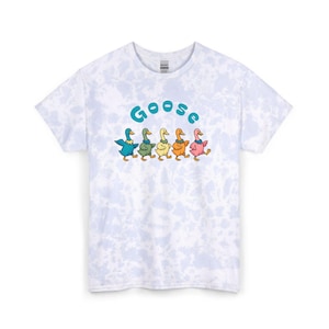 May include: A light blue and white tie-dye t-shirt featuring a graphic of five colourful geese walking in a row. Above the geese, the word "Goose" is printed in a bold, rounded blue font. The geese are coloured blue, green, yellow, orange, and pink.