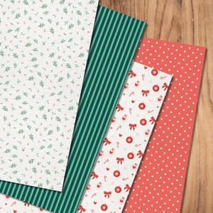 May include: Four sheets of patterned paper with Christmas themes. The first sheet has a white background with small green leaves and red berries. The second sheet has green and white stripes. The third sheet has a white background with red bows, candy canes, and ornaments. The fourth sheet has a red background with white polka dots.