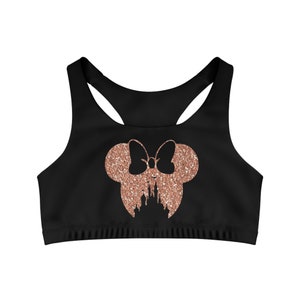 May include: Black sports bra with a rose gold glitter Minnie Mouse head design featuring a castle inside the bow.