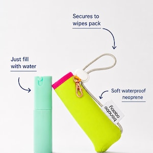May include: A light green spray bottle and a neon yellow neoprene pouch with a pink trim, a white cord loop, and a rose gold metal clip. The pouch features a white tag with the text 'bonobo' and includes text labels: 'Just fill with water' and 'Secures to wipes pack'.