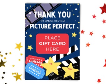 May include: A blue and white gift card holder with a movie theme. It features a red box with the text "Place Gift Card Here" and two blue and white movie ticket stubs with the text "Cinema". The background is a dark blue with white stars and a film strip.