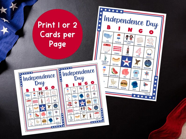 May include: Two Independence Day Bingo cards with red, white, and blue borders. Each card features a grid of illustrated icons, including the Statue of Liberty, fireworks, and a bald eagle. A red circle with white text reads "Print 1 or 2 Cards per Page."