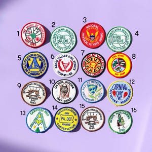 May include: A collection of sixteen vintage Boyertown, Pennsylvania patches. The patches are round and feature various designs, including text, illustrations, and the years 1980-1983. The patches are in various colors, including red, green, blue, yellow, and white.
