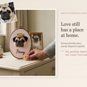 May include: An oval embroidery hoop containing a needle-felted pug portrait with a halo, mounted on pink and white striped fabric. The name Penny is embroidered below the pug. Text on the right reads: Love still has a place at home.