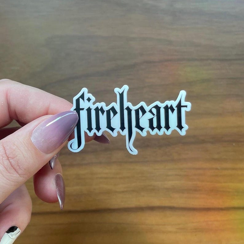 May include: A white sticker with the word "fireheart" written in black gothic lettering.