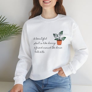 May include: White sweatshirt with a green plant in a pot illustration and the text "A beautiful plant is like having a friend around the house. -beth ditto"