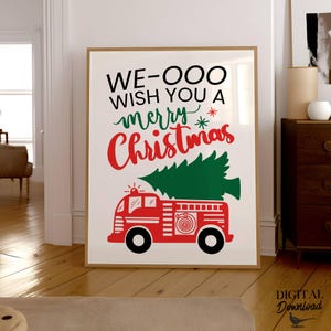 May include: A red fire truck with a green Christmas tree on top. The truck has a white hose and a black ladder. The text "WE-OOO WISH YOU A merry Christmas" is written in black on a white background.