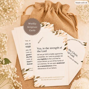 May include: A set of rectangular scripture cards featuring printed text and botanical illustrations, housed in a tan burlap drawstring pouch. The cards display religious verses including Mosiah 9:17, with arched borders and floral accents in muted earth tones.