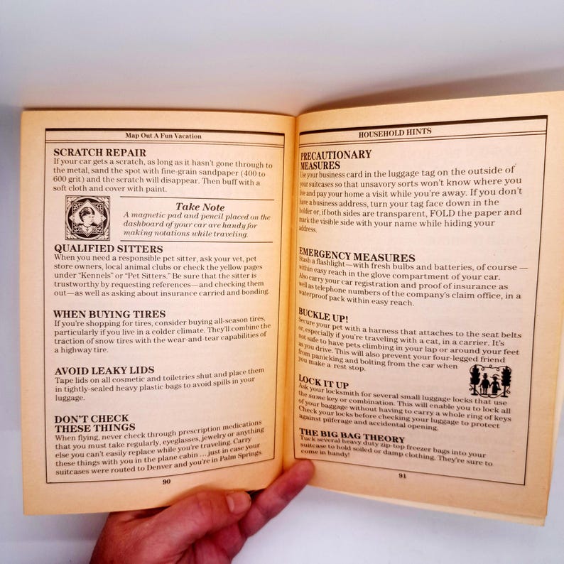 May include: Open book with travel tips, including scratch repair, pet sitter advice, and packing suggestions. The page also offers advice on emergency measures and luggage security. The text is in black on a yellowed page.