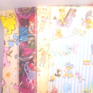 May include: Three sheets of decorative wrapping paper featuring vintage-style illustrations. One sheet displays children and flowers on a yellow background, another shows a dark pink scene with figures, and the third features blue stripes with toys.