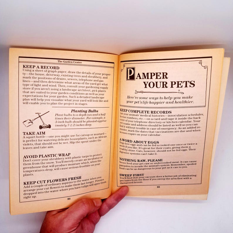 May include: Open book pages with text about gardening and pet care. The left page has instructions on keeping records and planting bulbs. The right page has the title "Pamper Your Pets" and tips for pet health.