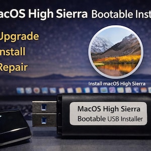 May include: A black USB flash drive labeled MacOS High Sierra Bootable USB Installer with a detached cap. The text on the drive indicates it is for upgrade, install, and repair, featuring a circular icon of a mountain landscape.