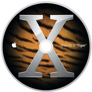 May include: A silver "X" logo over a tiger-striped background on a CD. The Apple logo is in the upper left. The text "Mac OS X "Tiger"" is printed on the bottom right of the CD.