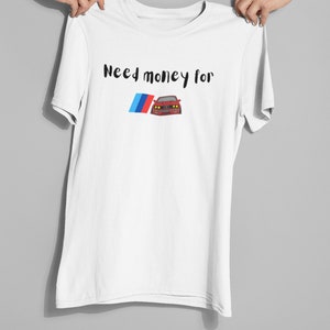 May include: White t-shirt with the text "Need money for" and a cartoon image of a red BMW M3 with the BMW logo.