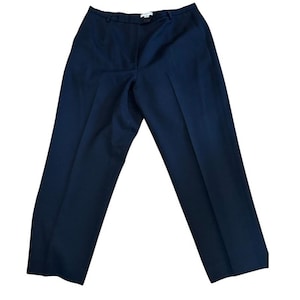 May include: Navy blue dress pants with a classic, tailored design. The pants feature a flat front, belt loops, and a straight leg. The fabric appears to be a medium-weight material, suitable for various occasions.