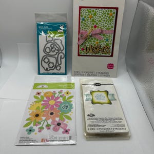 May include: A set of three ceramic mugs with a speckled, matte finish. Each mug features a different color: light blue, cream, and gray. The mugs have a simple, modern design with a rounded shape and a comfortable handle.