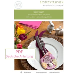 Könnte beinhalten: Ein weißer Teller mit einem lila und gemusterten Besteckhalter in Form eines Hasenohrs, der eine Gabel und ein Messer hält. Das Bild enthält den Text "PDF Deutsche Anleitung" und "Osterhasen". Die Höhe beträgt ca. 32 cm.
