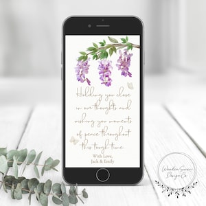 May include: A smartphone displays a digital card with a floral design. The card features purple wisteria blossoms and the text "Holding you close in our thoughts and wishing you moments of peace throughout this tough time."