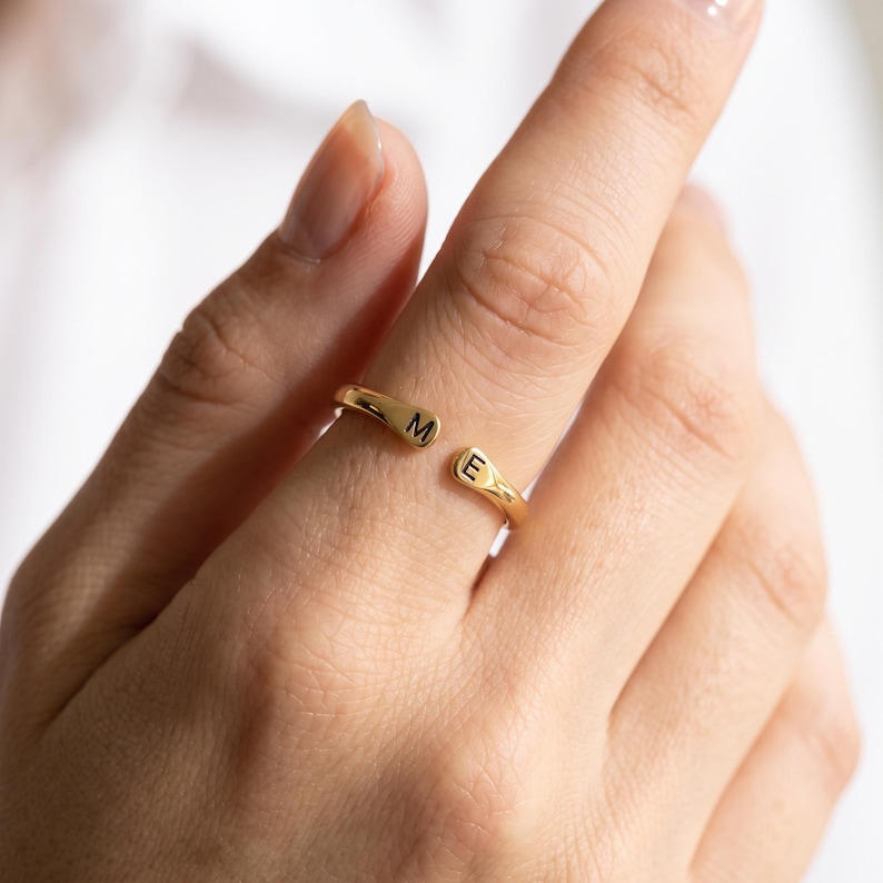 A breathtakingly elegant adjustable initial ring designed to combine modern versatility with deeply personalized meaning. This stunning 925 sterling silver piece features a sleek, open-cuff design with your choice of two custom-engraved letters on each resting end. Whether you are keeping a loved one's initial close to your own, representing your children, or looking for the perfect everyday signature piece, this wrap ring is the ultimate bespoke accessory.
