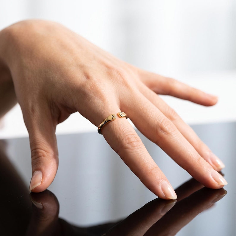 A breathtakingly elegant adjustable initial ring designed to combine modern versatility with deeply personalized meaning. This stunning 925 sterling silver piece features a sleek, open-cuff design with your choice of two custom-engraved letters on each resting end. Whether you are keeping a loved one's initial close to your own, representing your children, or looking for the perfect everyday signature piece, this wrap ring is the ultimate bespoke accessory.