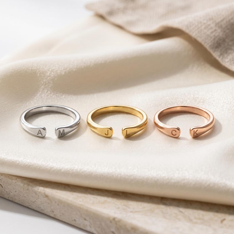 A breathtakingly elegant adjustable initial ring designed to combine modern versatility with deeply personalized meaning. This stunning 925 sterling silver piece features a sleek, open-cuff design with your choice of two custom-engraved letters on each resting end. Whether you are keeping a loved one's initial close to your own, representing your children, or looking for the perfect everyday signature piece, this wrap ring is the ultimate bespoke accessory.