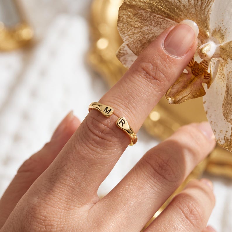 A breathtakingly elegant adjustable initial ring designed to combine modern versatility with deeply personalized meaning. This stunning 925 sterling silver piece features a sleek, open-cuff design with your choice of two custom-engraved letters on each resting end. Whether you are keeping a loved one's initial close to your own, representing your children, or looking for the perfect everyday signature piece, this wrap ring is the ultimate bespoke accessory.