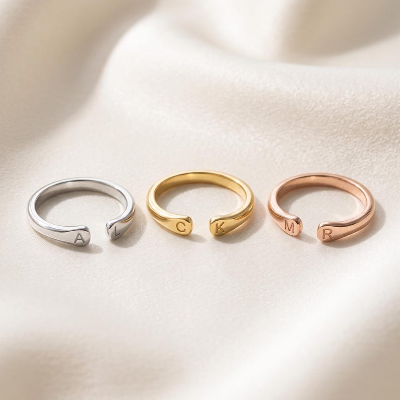 A breathtakingly elegant adjustable initial ring designed to combine modern versatility with deeply personalized meaning. This stunning 925 sterling silver piece features a sleek, open-cuff design with your choice of two custom-engraved letters on each resting end. Whether you are keeping a loved one's initial close to your own, representing your children, or looking for the perfect everyday signature piece, this wrap ring is the ultimate bespoke accessory.