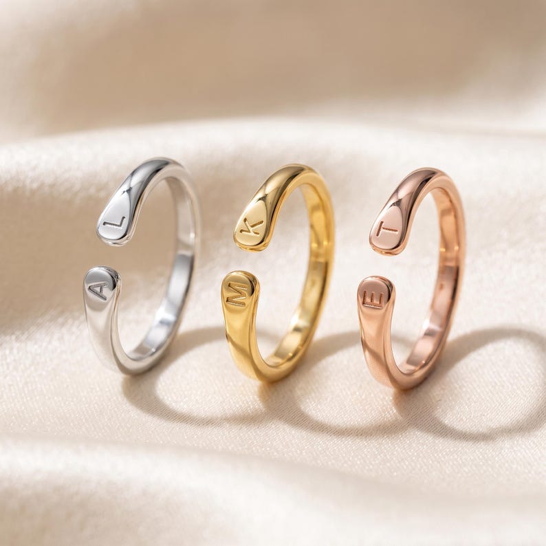 A breathtakingly elegant adjustable initial ring designed to combine modern versatility with deeply personalized meaning. This stunning 925 sterling silver piece features a sleek, open-cuff design with your choice of two custom-engraved letters on each resting end. Whether you are keeping a loved one's initial close to your own, representing your children, or looking for the perfect everyday signature piece, this wrap ring is the ultimate bespoke accessory.