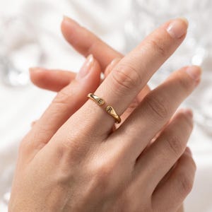 A breathtakingly elegant adjustable initial ring designed to combine modern versatility with deeply personalized meaning. This stunning 925 sterling silver piece features a sleek, open-cuff design with your choice of two custom-engraved letters on each resting end. Whether you are keeping a loved one's initial close to your own, representing your children, or looking for the perfect everyday signature piece, this wrap ring is the ultimate bespoke accessory.