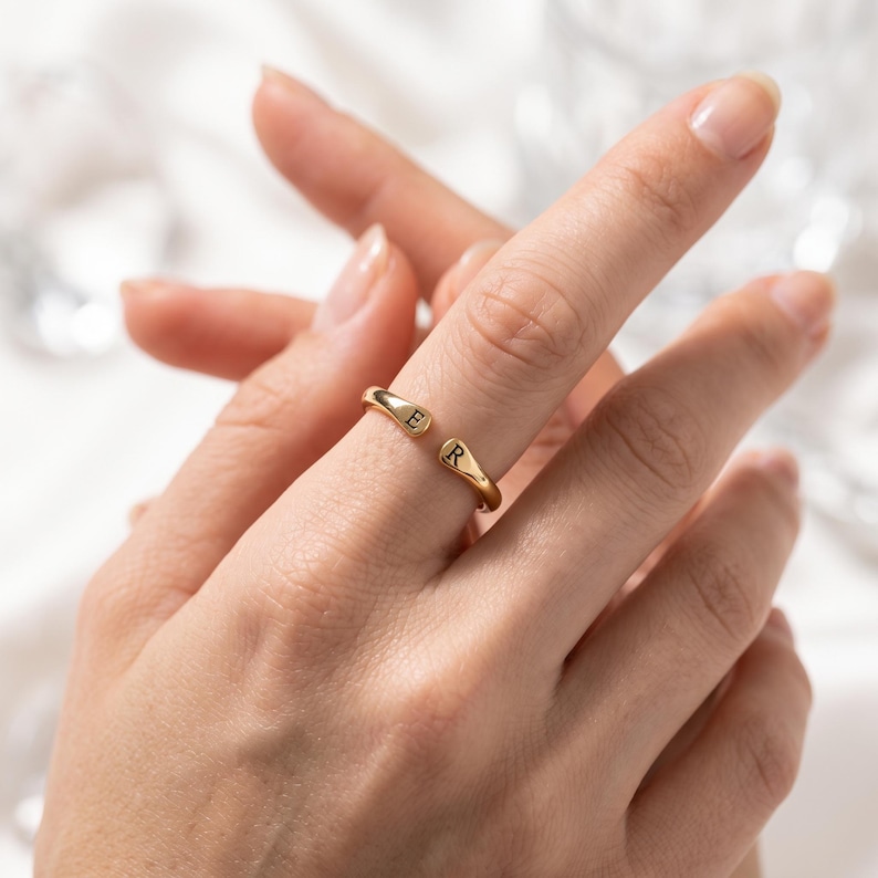 A breathtakingly elegant adjustable initial ring designed to combine modern versatility with deeply personalized meaning. This stunning 925 sterling silver piece features a sleek, open-cuff design with your choice of two custom-engraved letters on each resting end. Whether you are keeping a loved one's initial close to your own, representing your children, or looking for the perfect everyday signature piece, this wrap ring is the ultimate bespoke accessory.