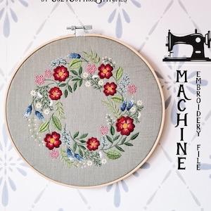 May include: A floral wreath embroidery design in a hoop with red, pink, white, and blue flowers. The design is labelled "MACHINE EMBROIDERY FILE".