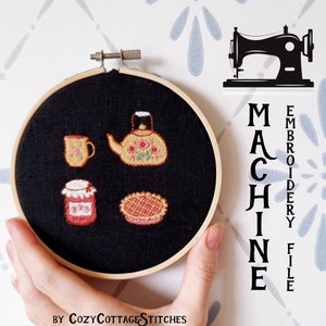 May include: A black embroidery hoop with a hand-stitched design of a teapot, a cup, a jar, and a pie. The hoop is held by a hand. The text "MACHINE EMBROIDERY FILE BY COZYCOTTAGE STITCHES" is visible on the white background.