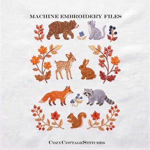 May include: Machine embroidery files featuring woodland animals including a brown bear, gray cat, fawn, rabbit, orange fox, raccoon, and squirrel, surrounded by autumn leaves, red berries, and blue berries, with text reading MACHINE EMBROIDERY FILES and COZYCOTTAGESTITCHES.