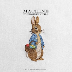 May include: Machine embroidery file featuring a brown rabbit wearing a blue jacket and carrying a basket of colorful eggs. The text "MACHINE EMBROIDERY FILE" is at the top, and "COZYCOTTAGESTITCHES" is at the bottom.
