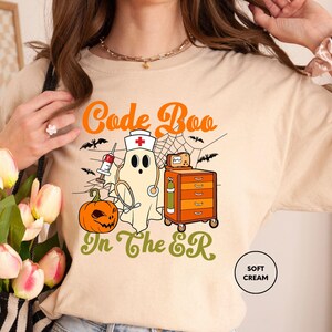 a woman wearing a t - shirt with a ghost on it