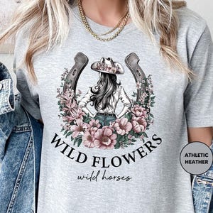 a woman wearing a t - shirt that says wild flowers