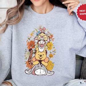 a woman wearing a sweatshirt with a cartoon character on it