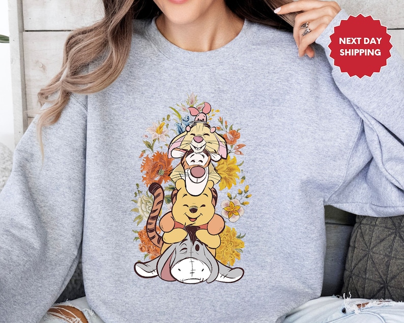 a woman wearing a sweatshirt with a cartoon character on it