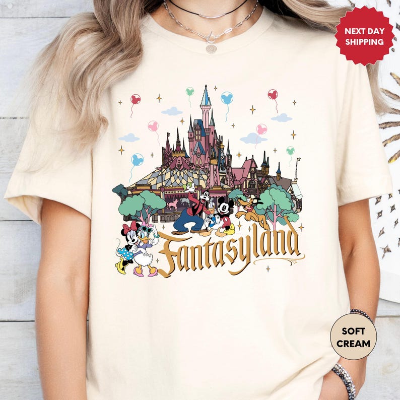 a woman wearing a tshirt with a picture of a castle on it