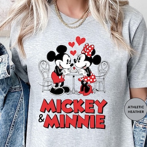 a woman wearing a mickey and minnie shirt
