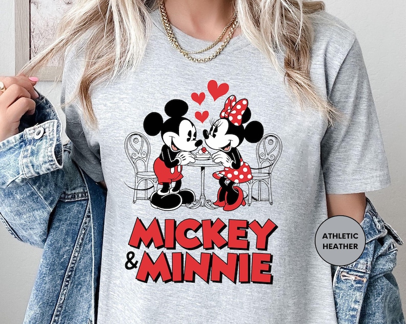 a woman wearing a mickey and minnie shirt