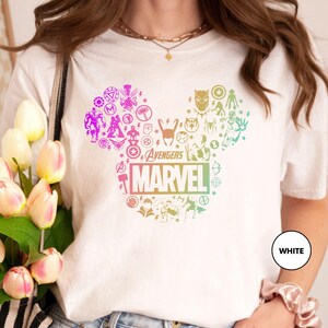 a woman holding a bouquet of tulips wearing a mickey mouse t - shirt