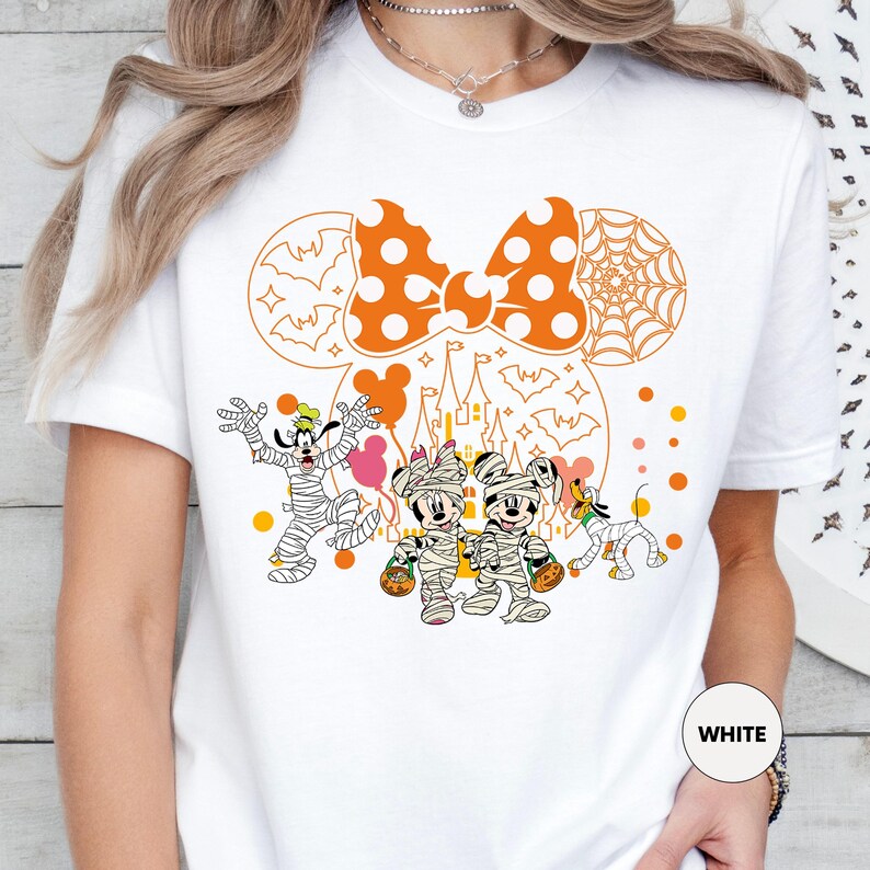 a woman wearing a white mickey mouse shirt