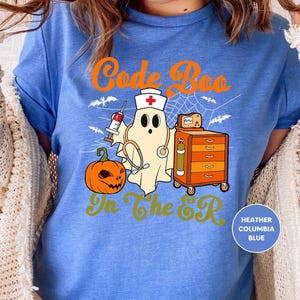 a woman wearing a blue shirt with a ghost on it