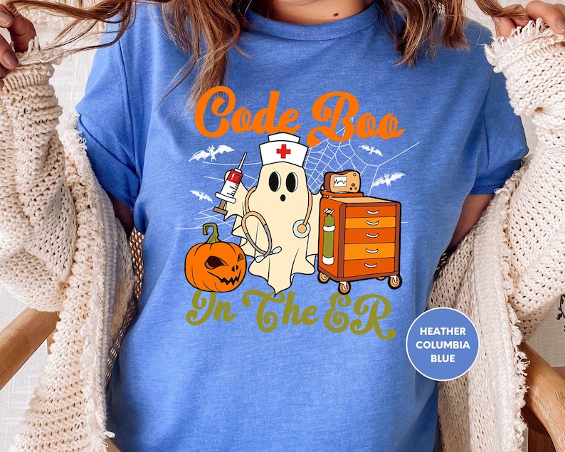 a woman wearing a blue shirt with a ghost on it