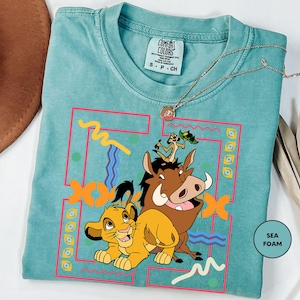 a t - shirt with a picture of a lion and a cow on it