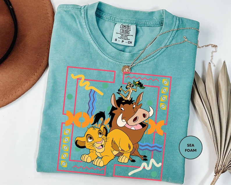 a t - shirt with a picture of a lion and a cow on it